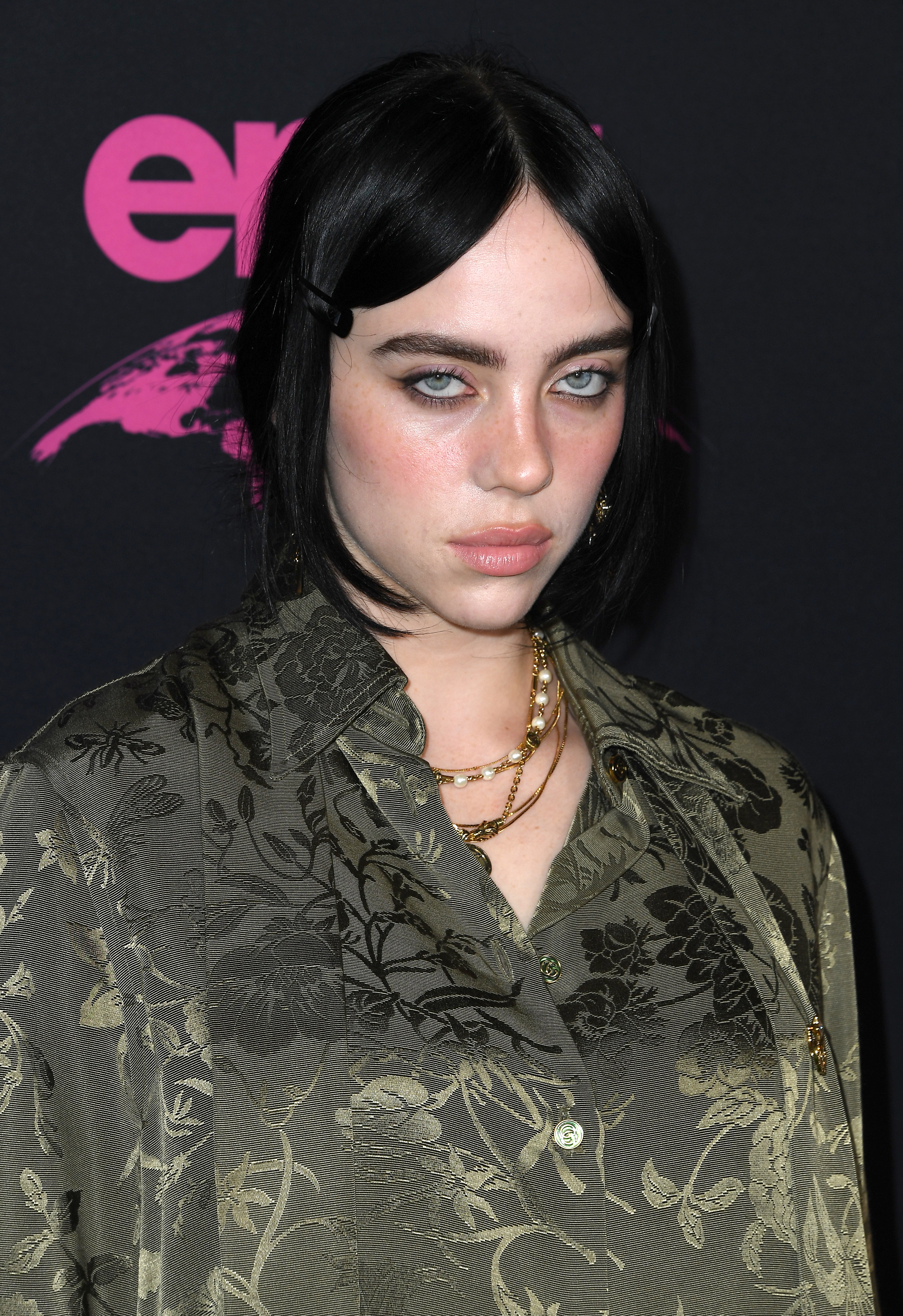 Close-up of Billie at a media event wearing a paisley outfit