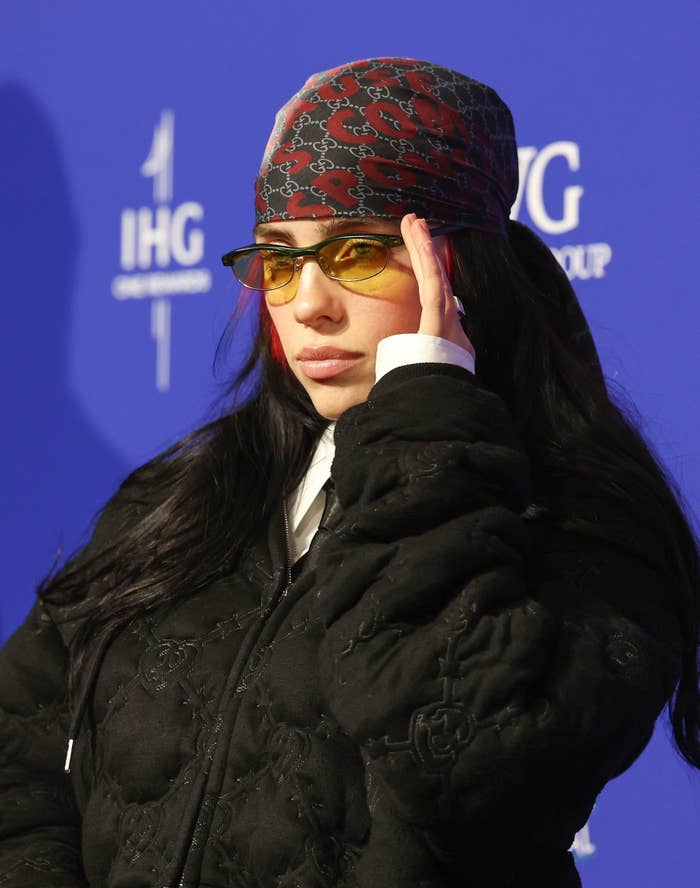A close-up of Billie wearing tinted sunglasses and a bandana