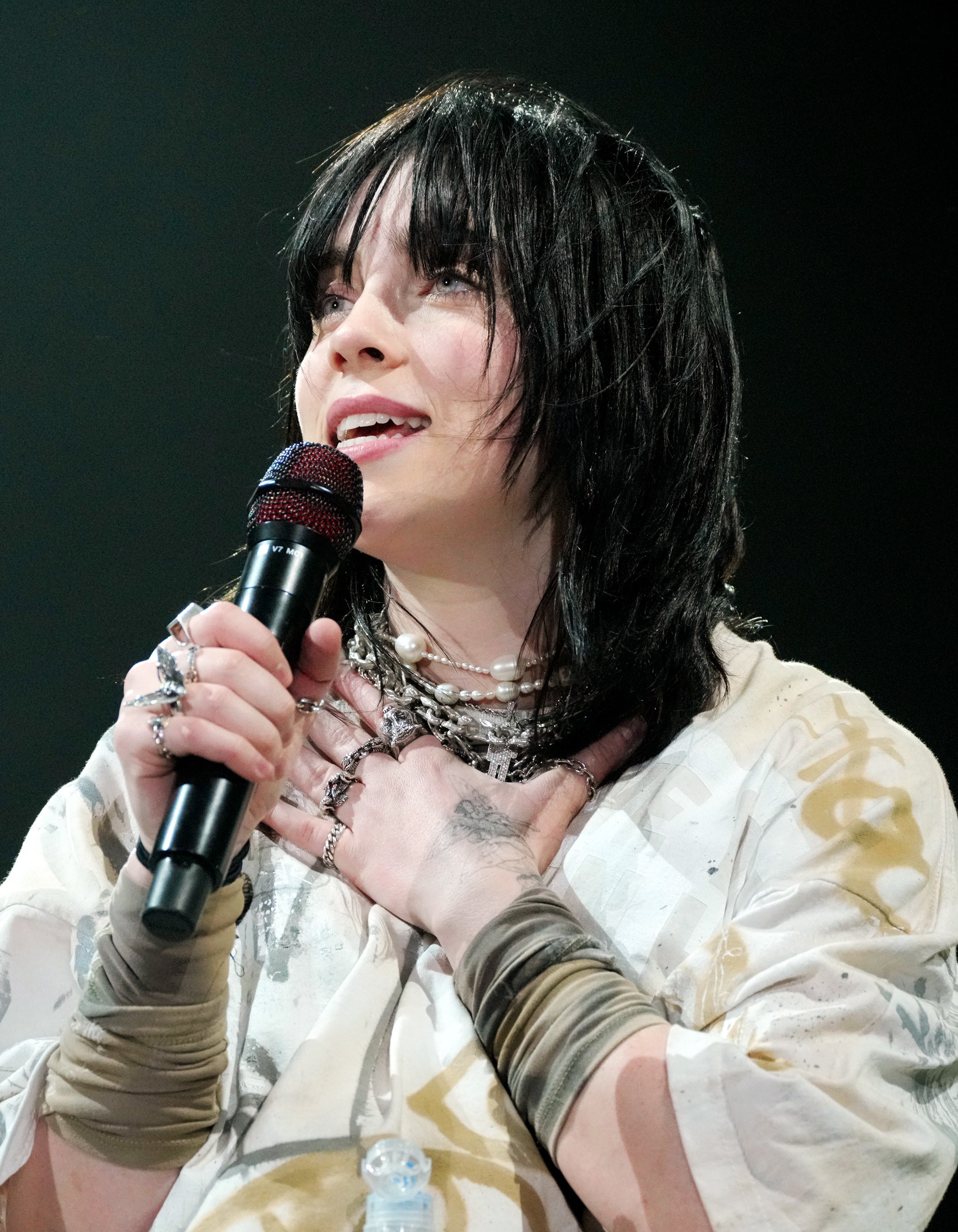 Close-up of Billie holding a microphone