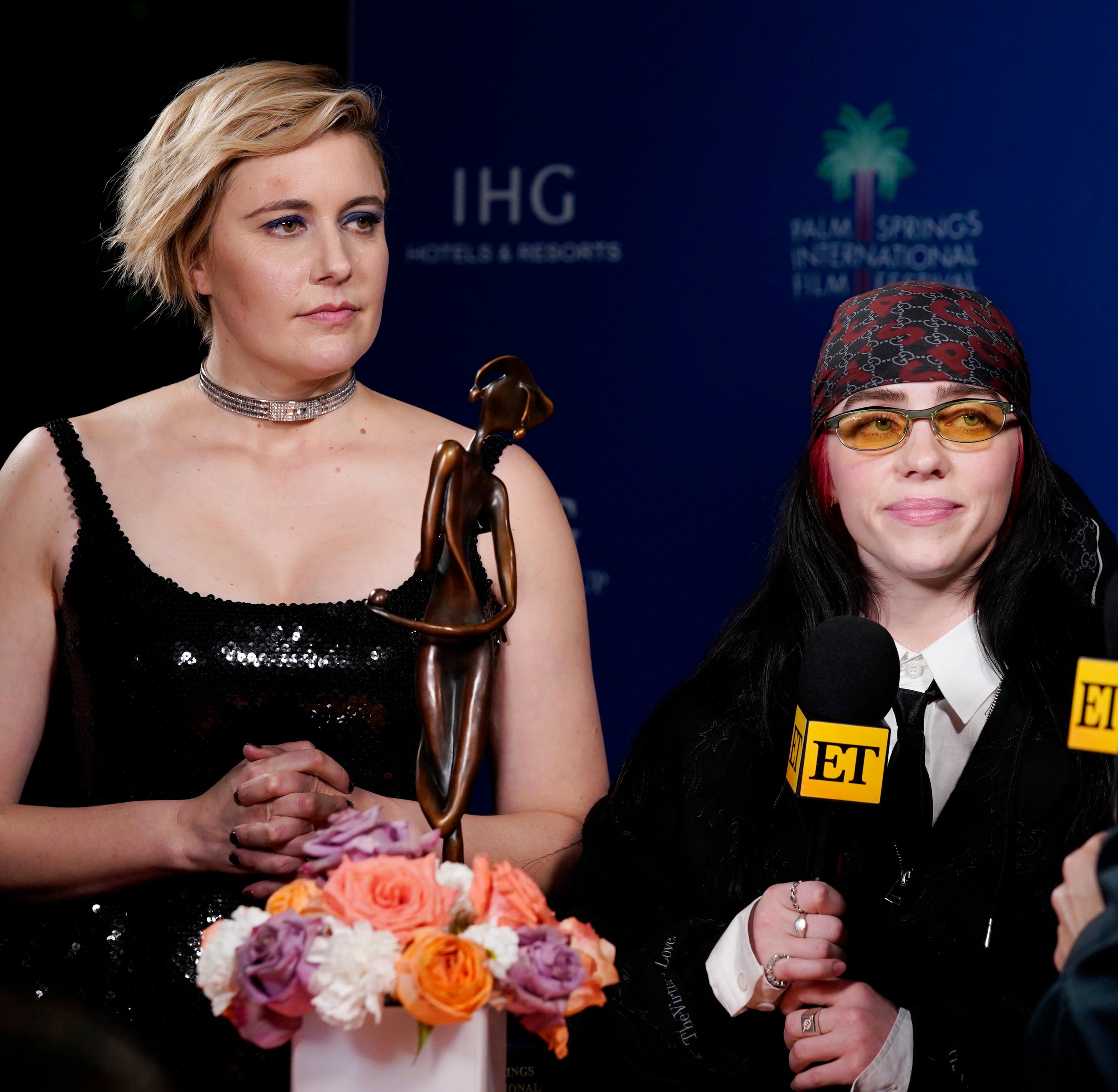 Greta and Billie at a media event being interviewed