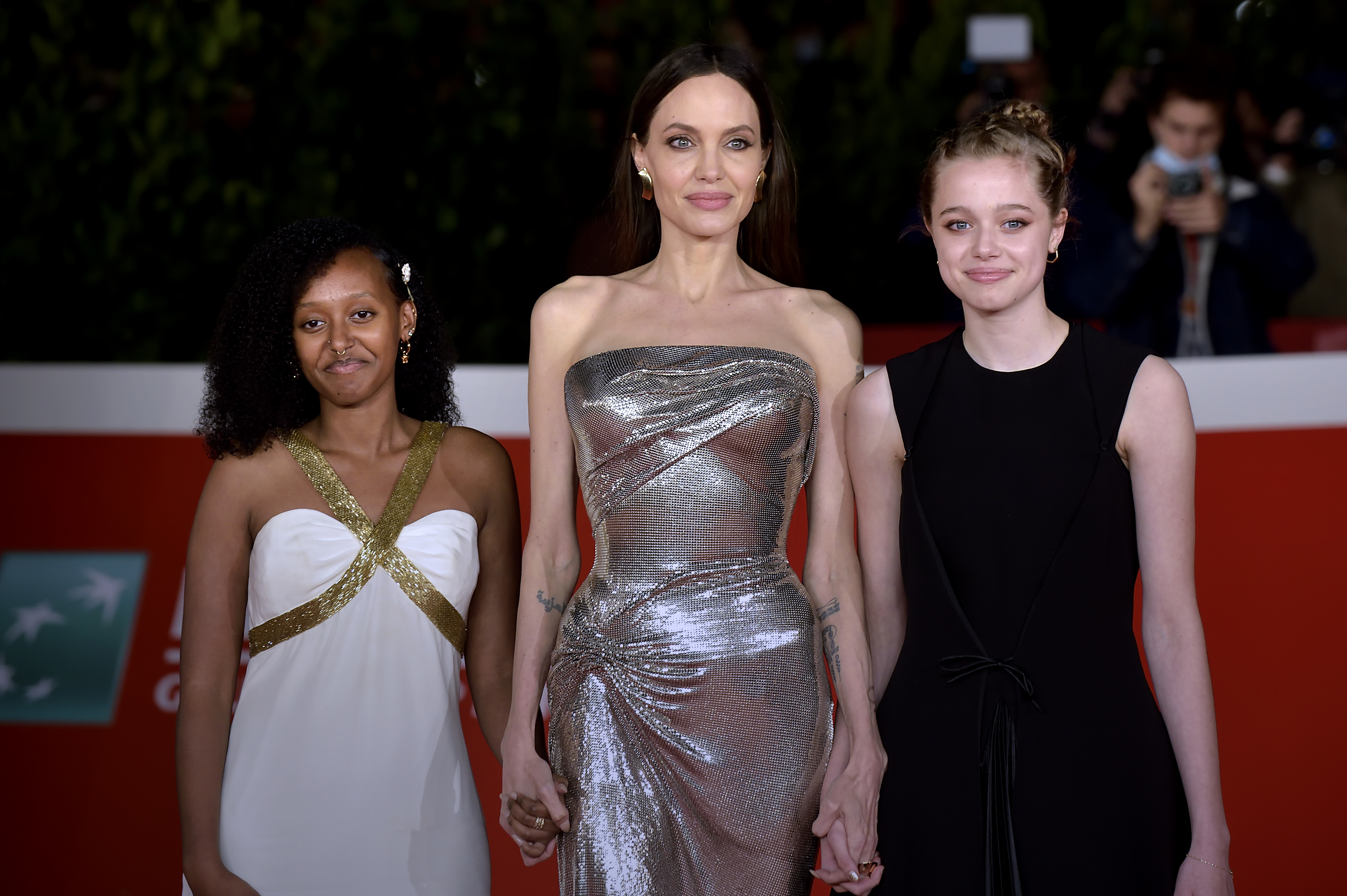 angelina with two of her daughters on the red carpet