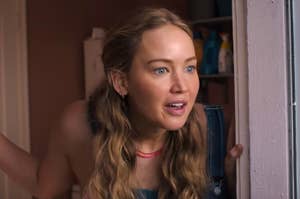 Jennifer Lawrence opening her eyes wide as she opens a door as Maddie in No Hard Feelings