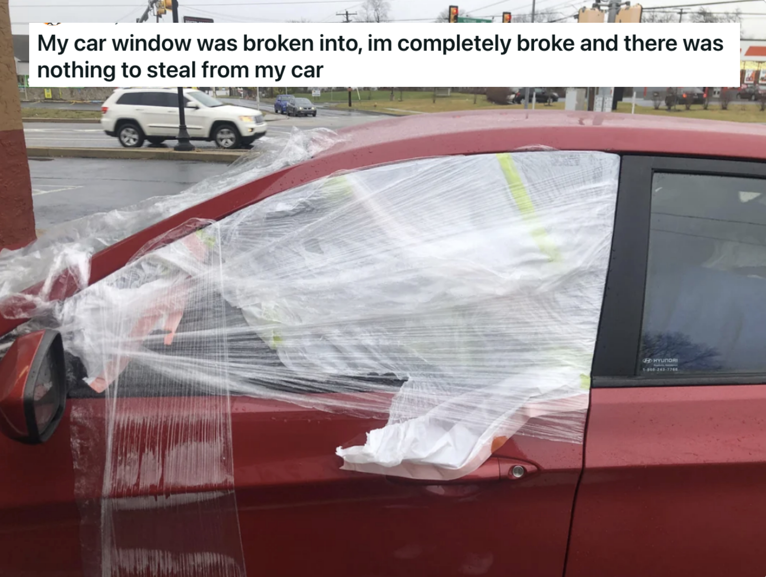 A broken window with plastic taped to it