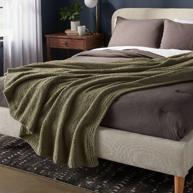 the blanket in restful green on a bed