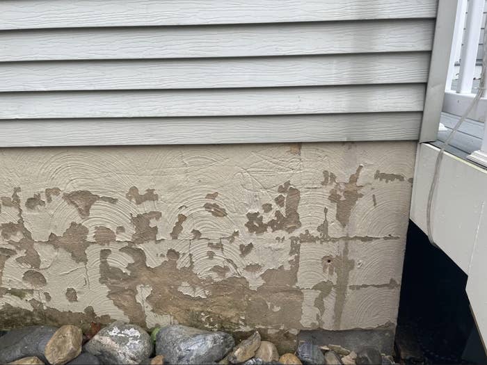 The exterior paint of a house has peeled