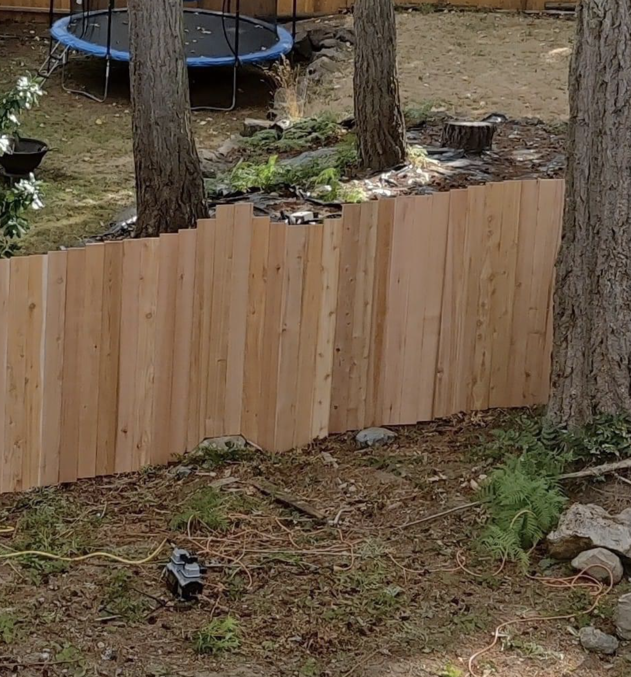 An uneven wooden fence has been put up