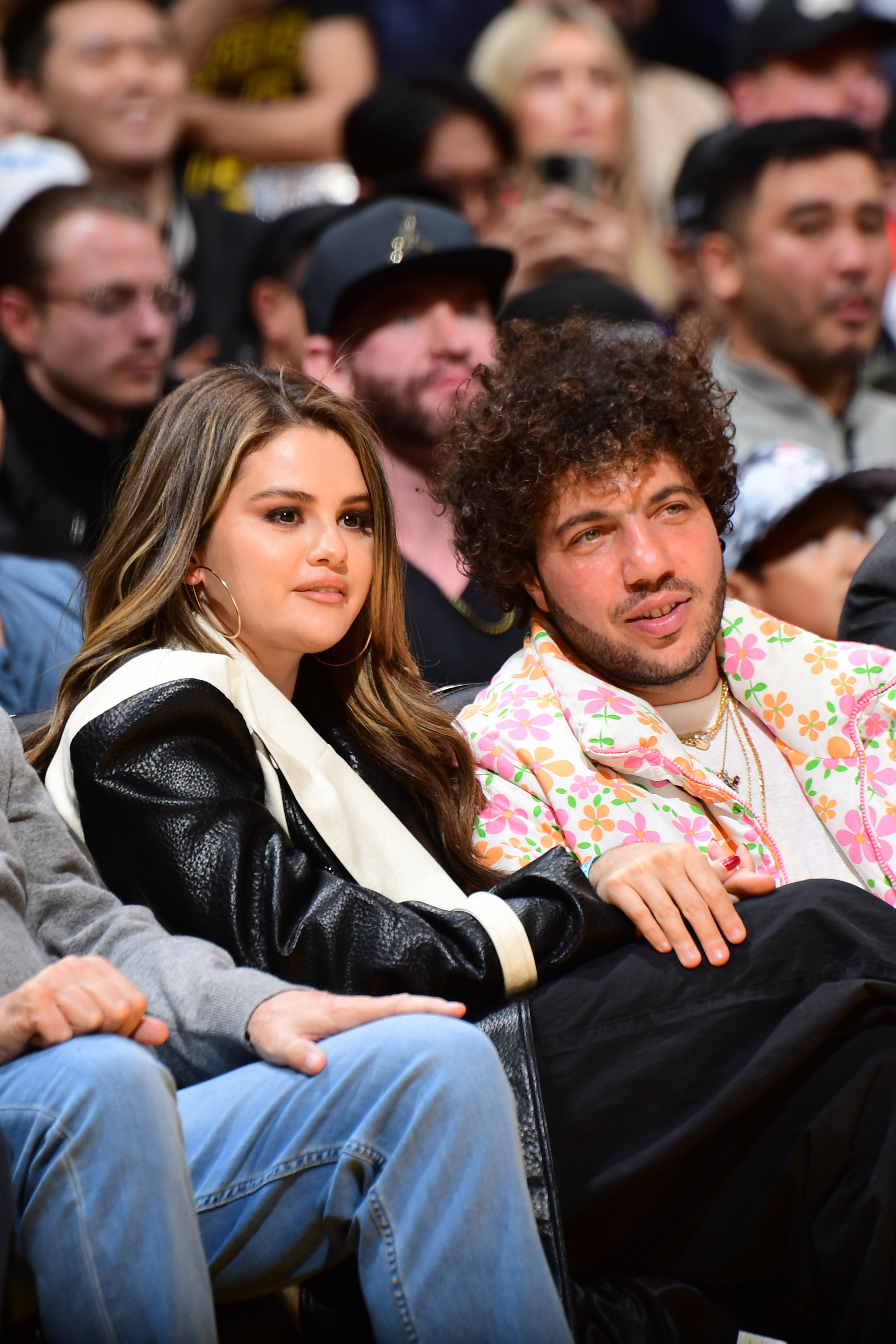 Close-up of Selena and Benny sitting together at a sports event