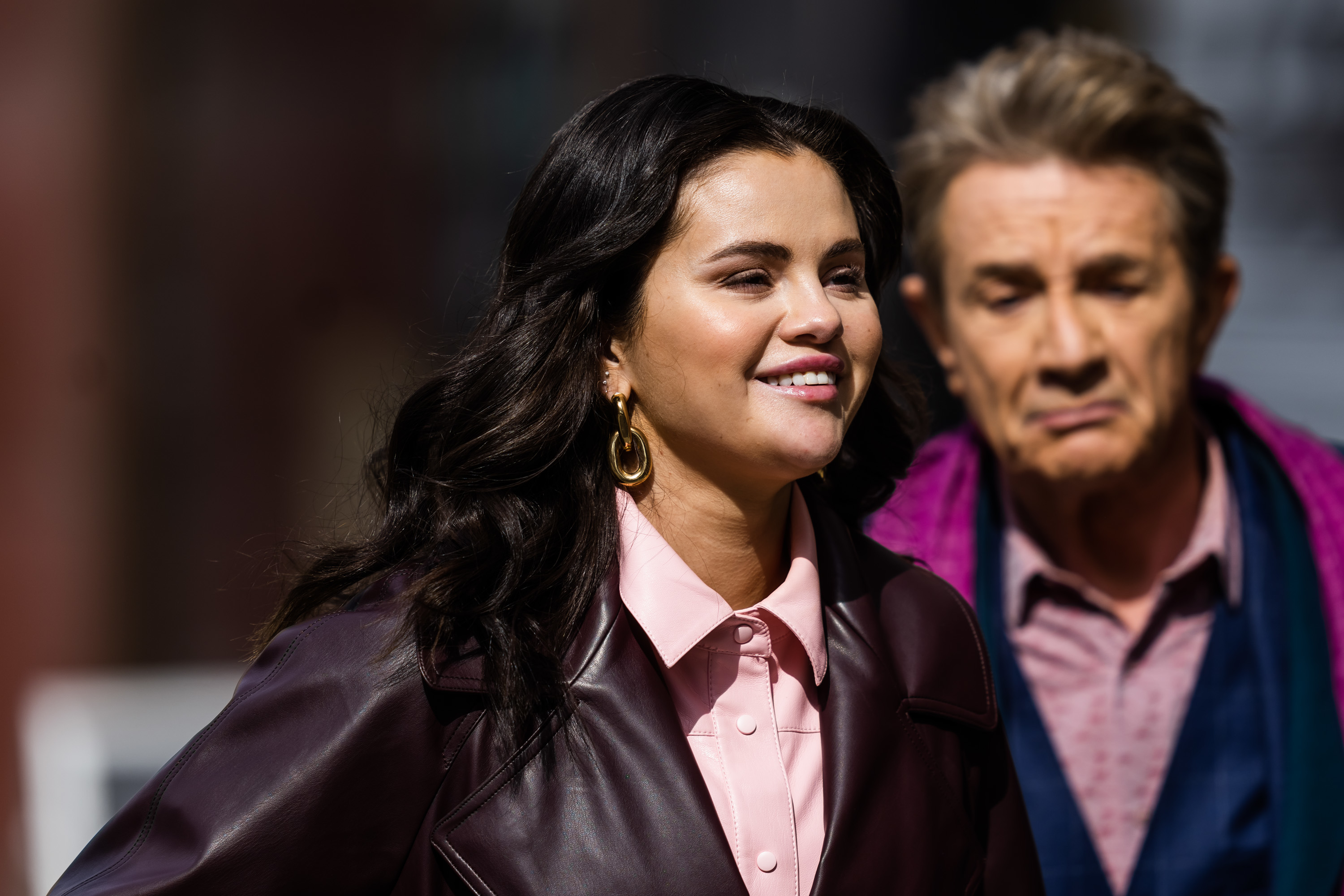 Close-up of Selena smiling with Only Murders in the Building costar Martin Short behind her