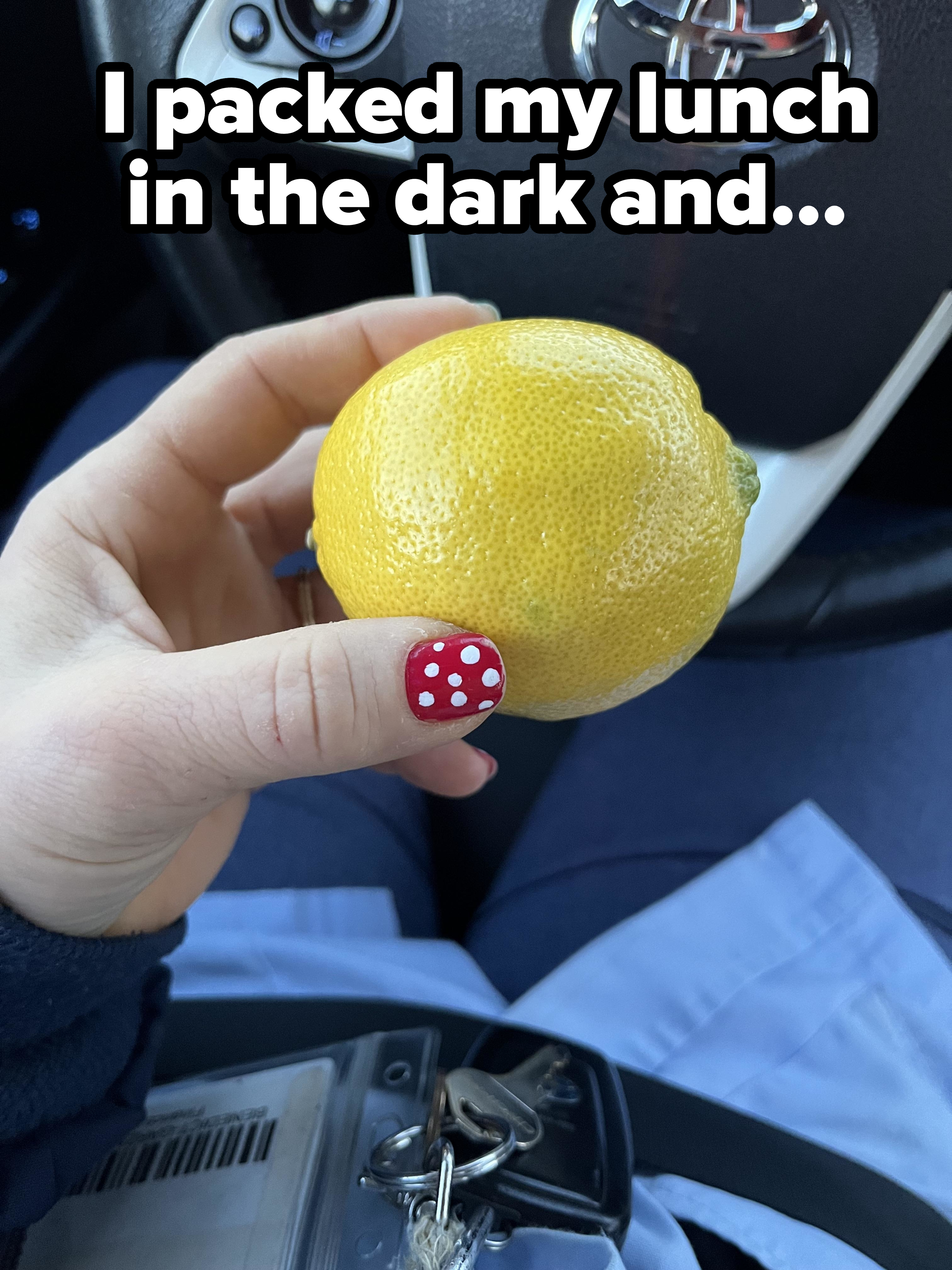 A person holding a lemon with caption &quot;I packed my lunch in the dark&quot;
