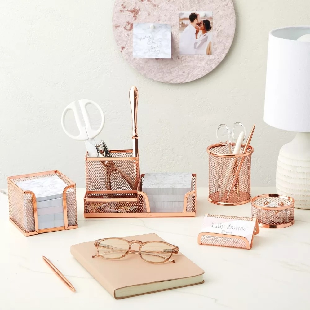 a set of rose gold matching desk organizers on a desk
