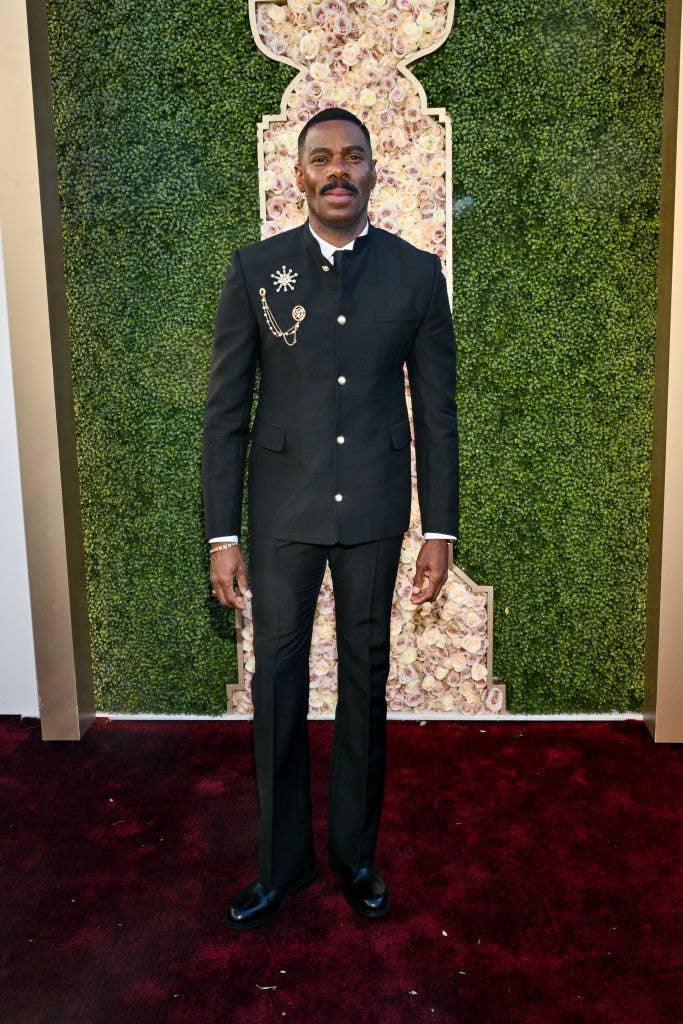 He&#x27;s wearing a suit with a few medallions