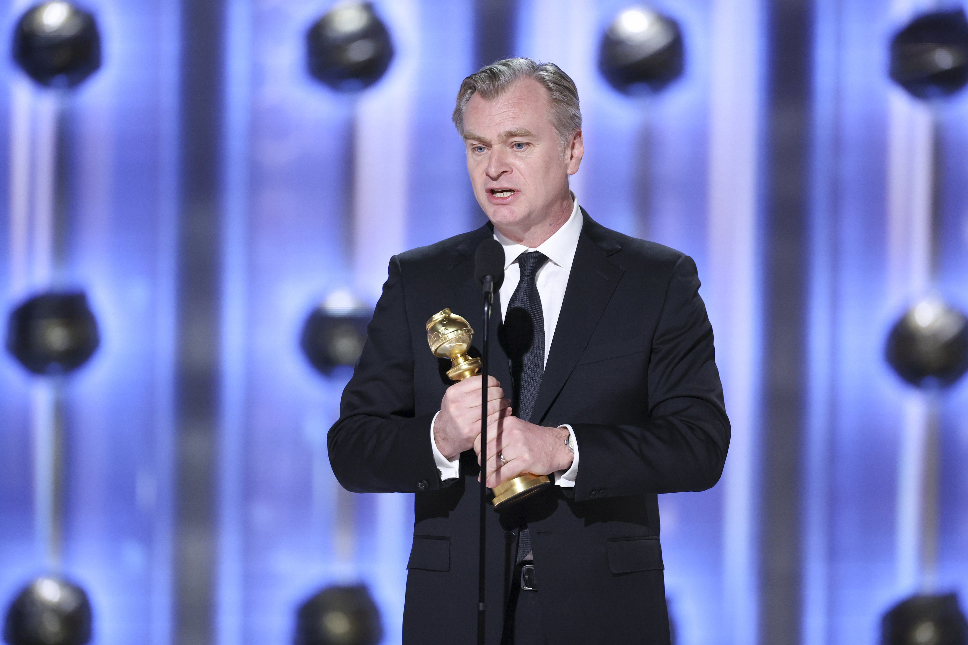 Christopher Nolan onstage accepting his award