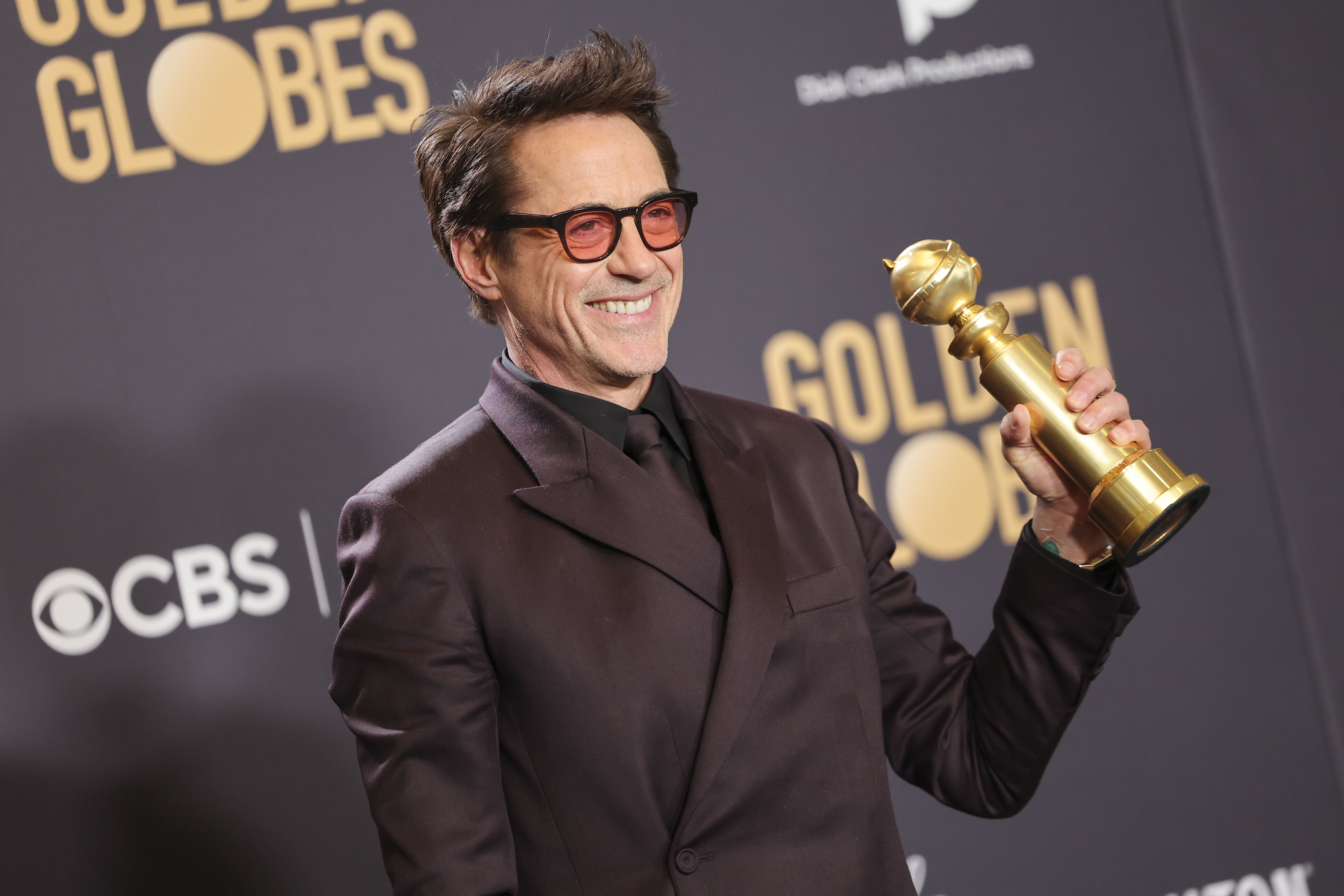 Robert Downey Jr. holding his Golden Globe