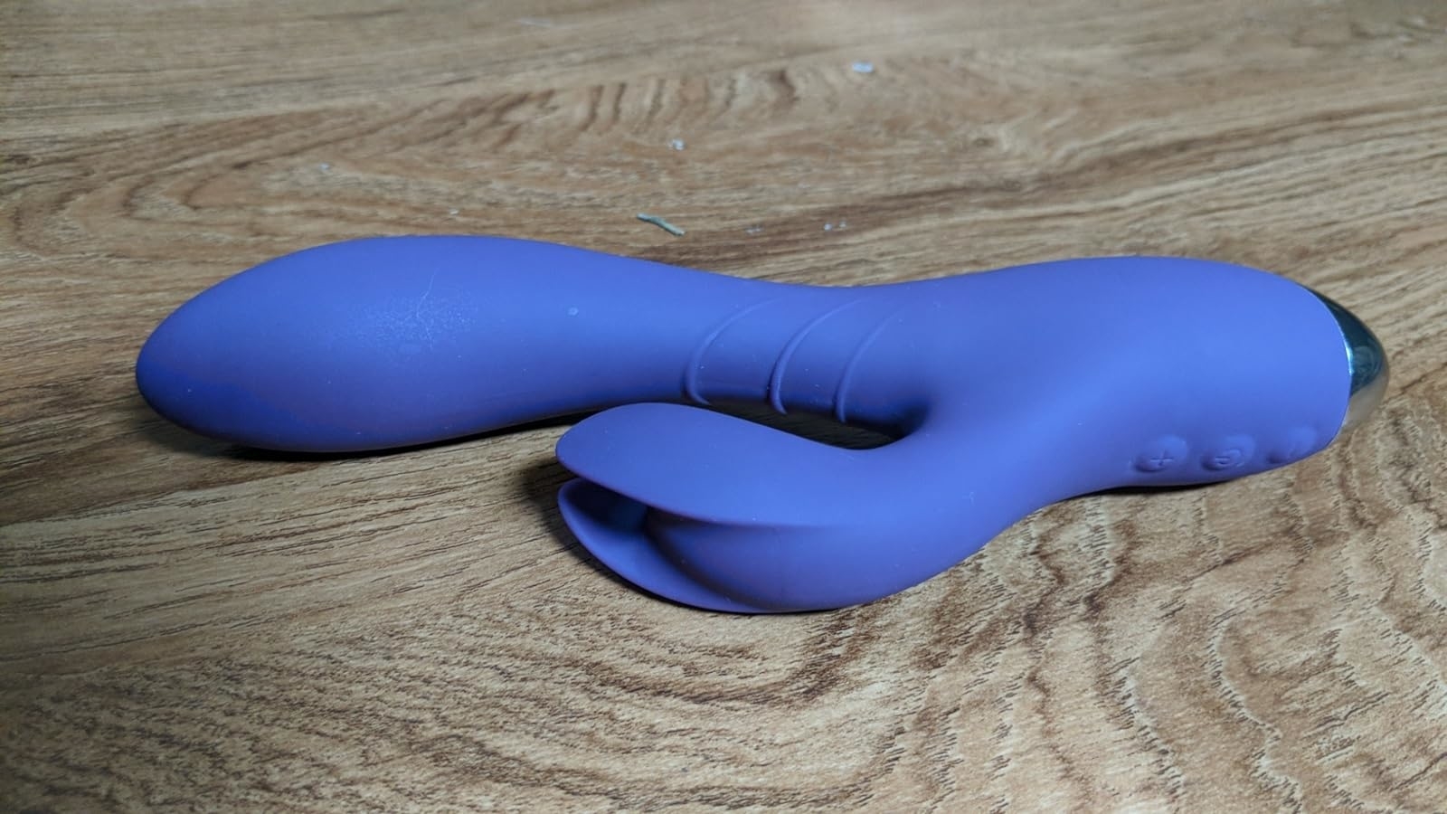reviewer&#x27;s purple rabbit vibrator with kneading clitoral arm on display