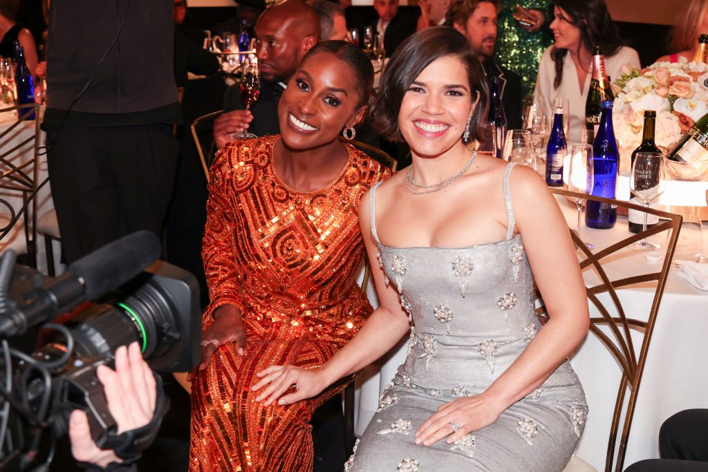 Issa Rae and America Ferrera sitting at a table
