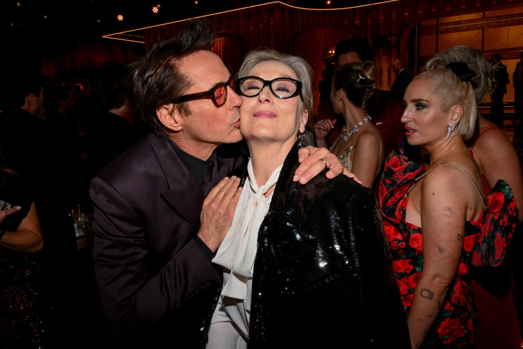 Robert Downey Jr. kissing Meryl Streep on the cheek