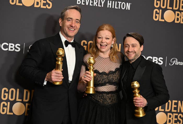 Matthew McFadyen, Sarah Snook, and Kieran Culkan smile as they hold their Golden Globe awards backstage