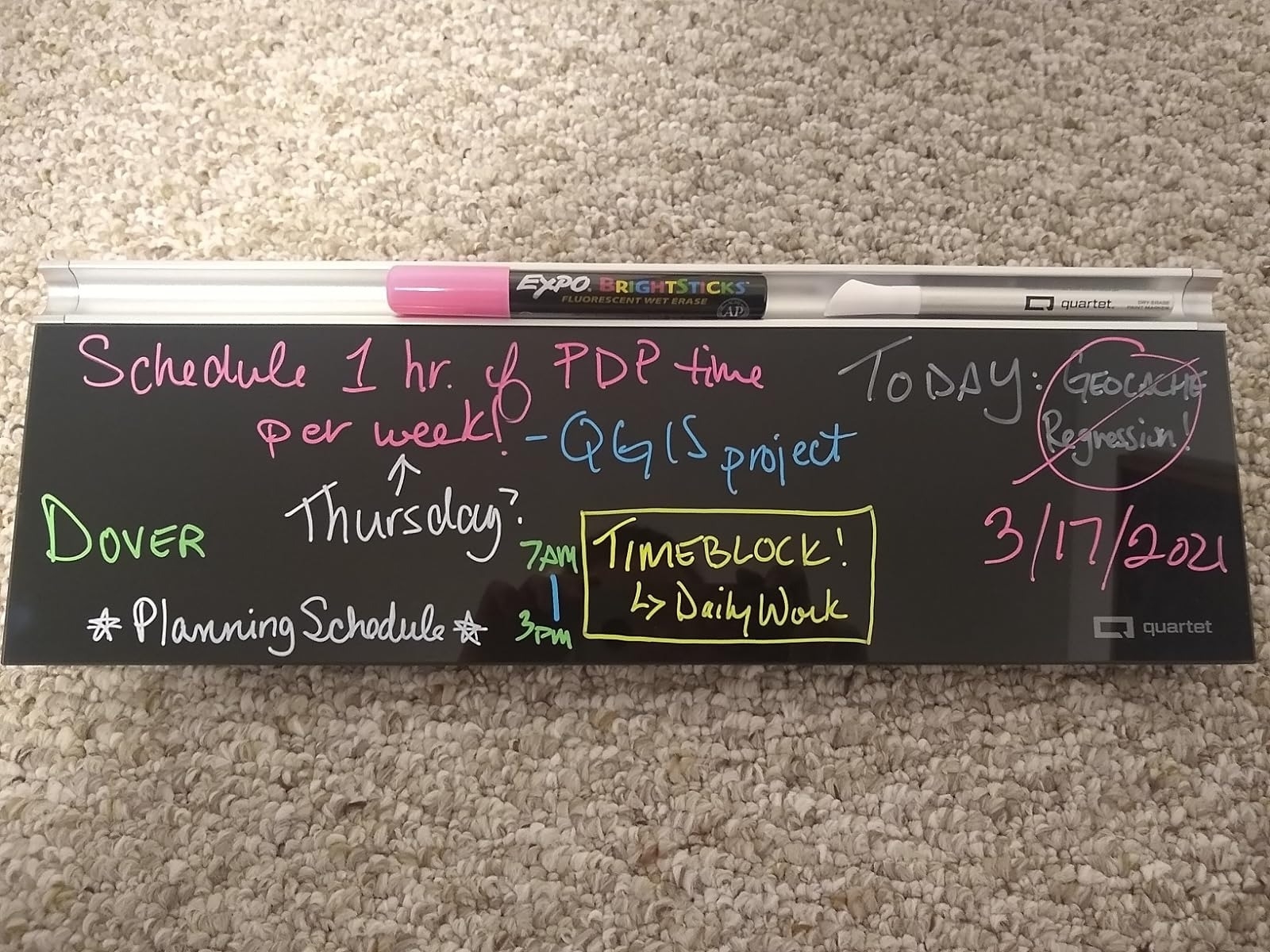 reviewer image of the black dry erase board with notes written in colorful markers