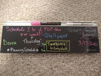 reviewer image of the black dry erase board with notes written in colorful markers
