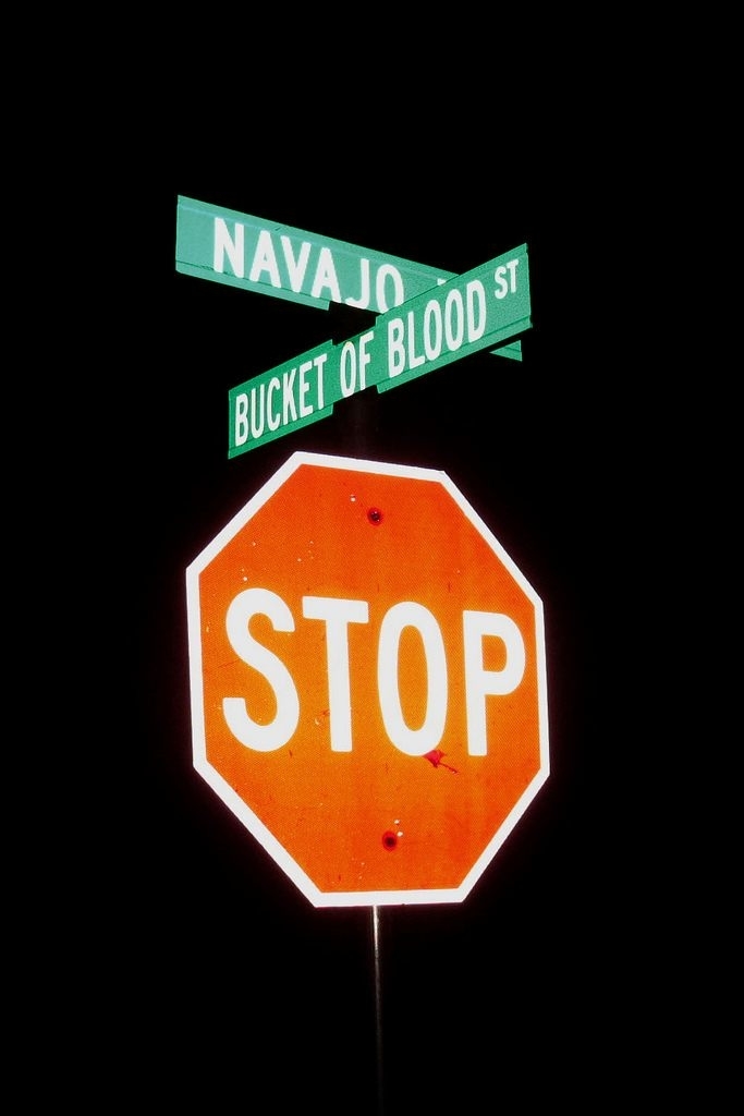 The street sign (with a &quot;Navajo&quot; cross street) above a stop sign