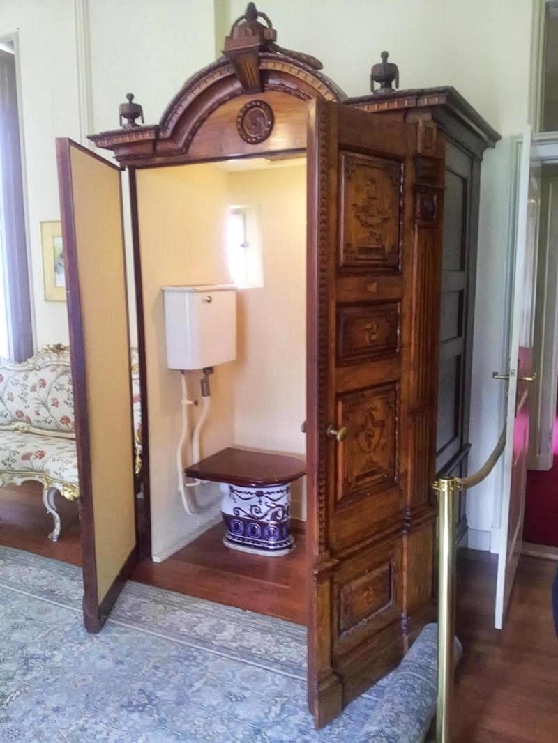 What looks like an armoire with a toilet and tank inside