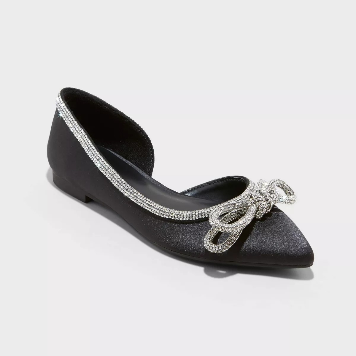 a pair of black ballet flats with a silver sparkly bow