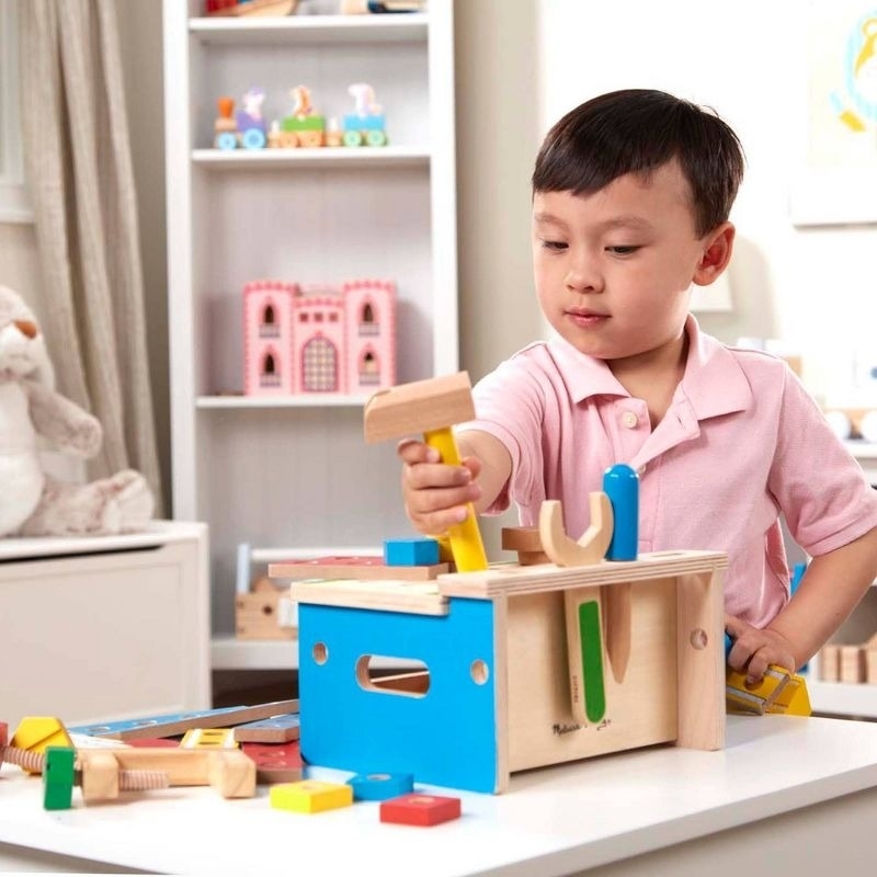 A child plays with a woodworking toy