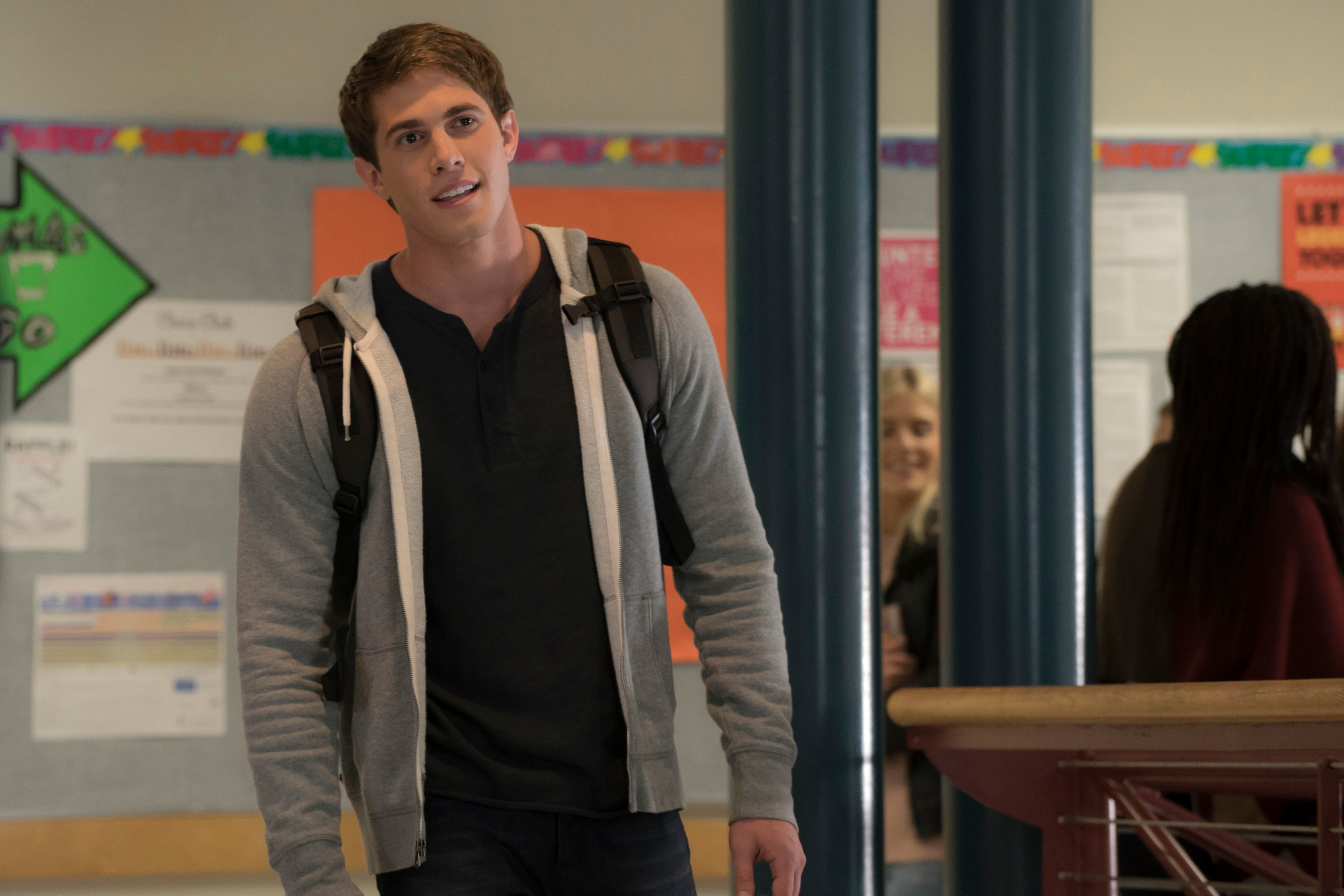 his character walking in a school hallway with a backpack