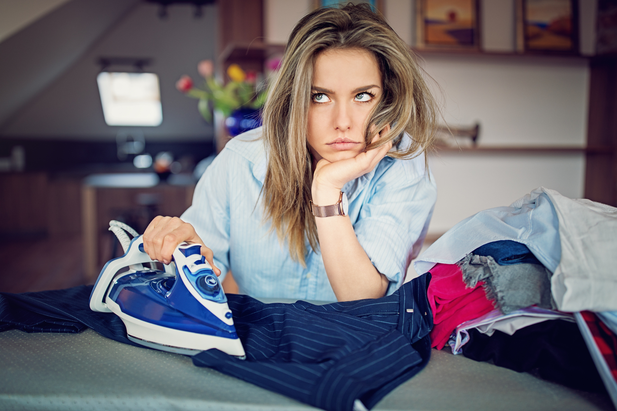 a woman looking bored while ironing