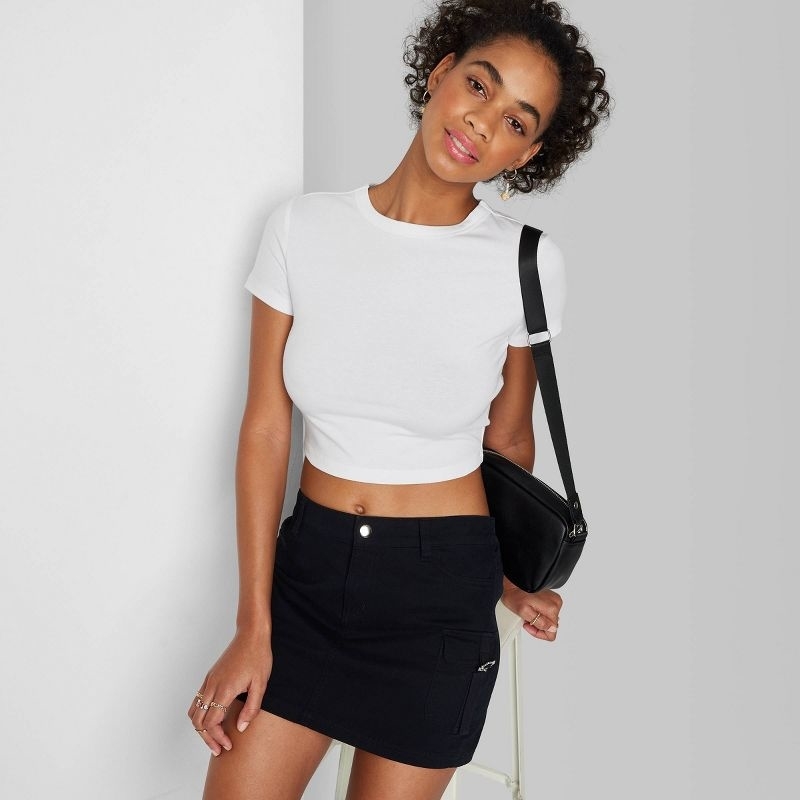 Model wearing the white crop top