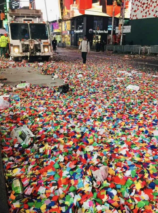 Times Square with the street covered with a massive amount of colorful debris