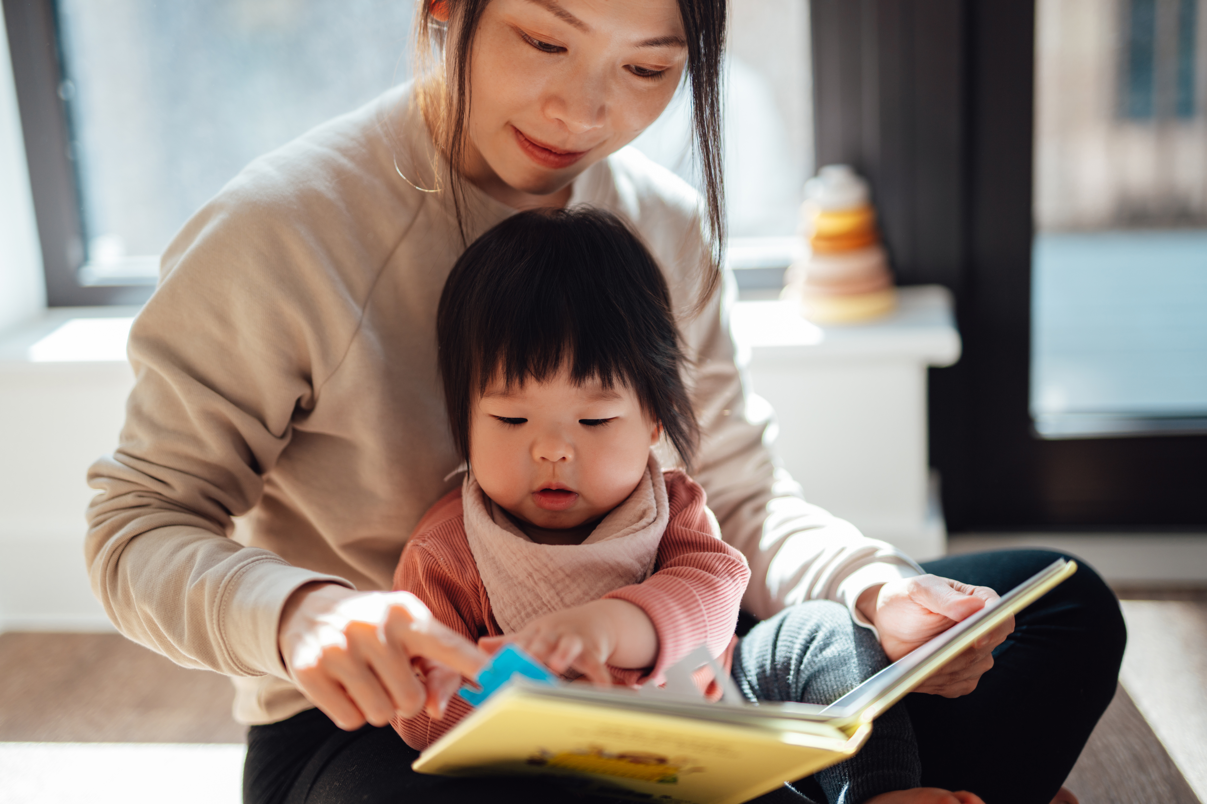 A young mom reading to her toddler