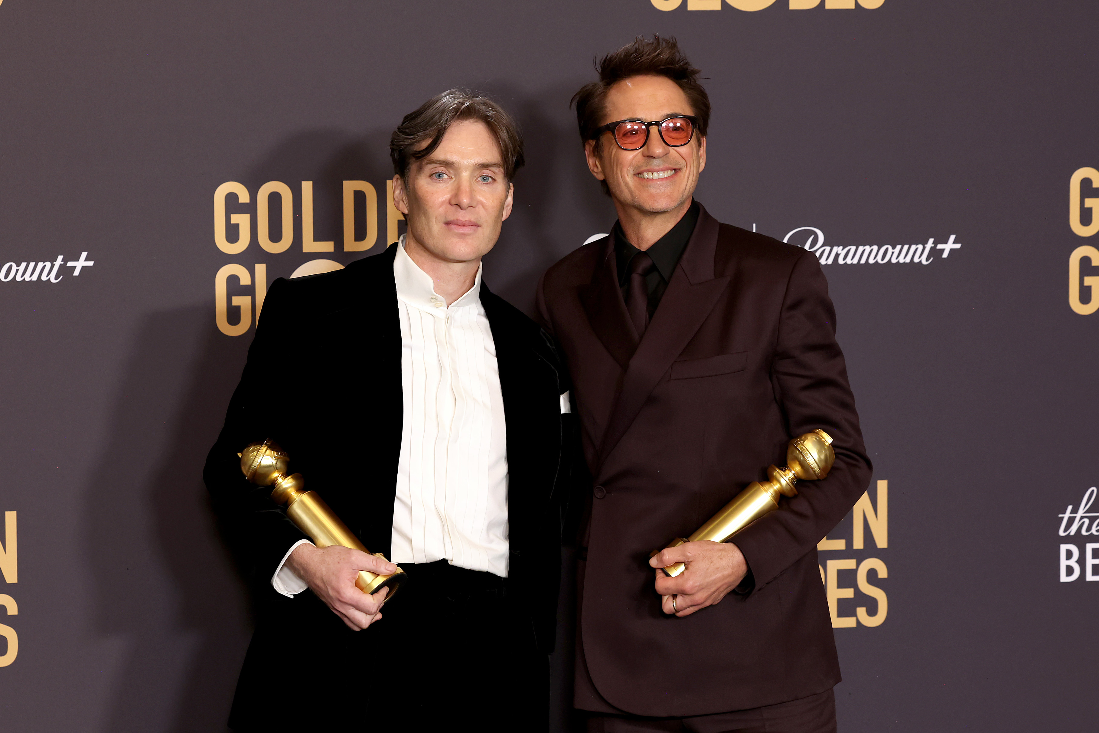 Cillian Murphy and Robert Downey Jr. pose for photos backstage as they hold their individual awards