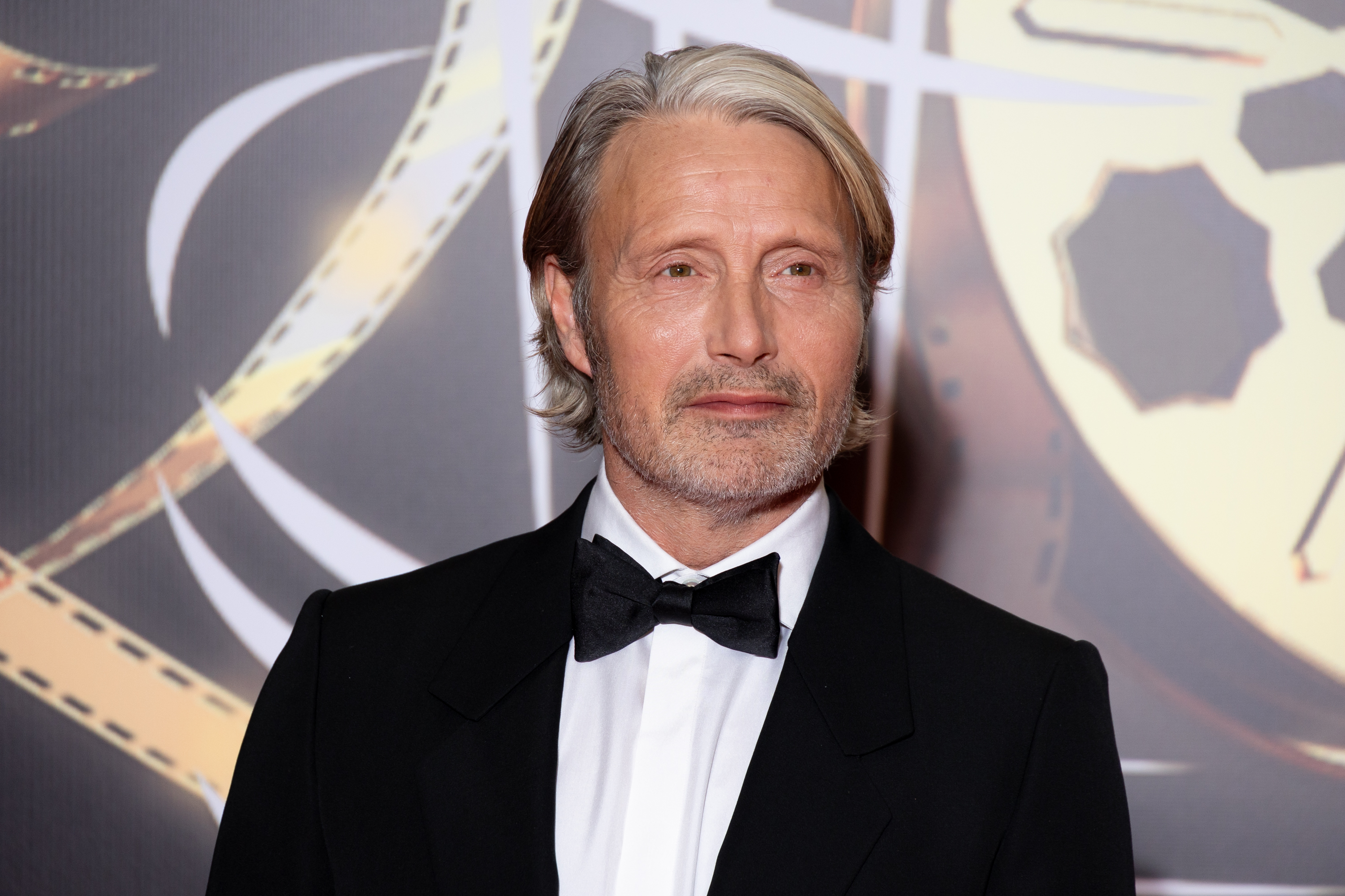 Mads at a media event in a tuxedo