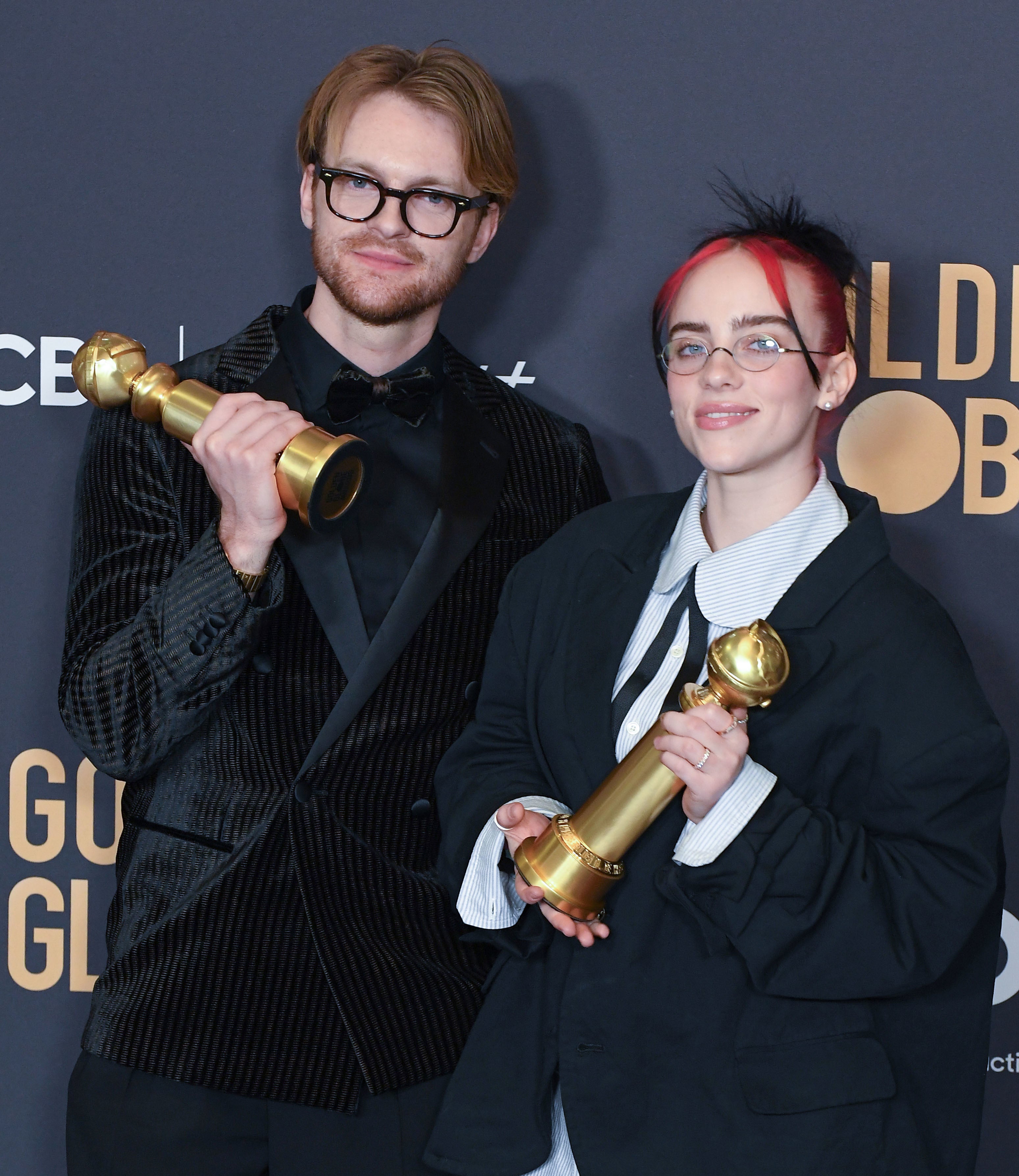 Finneas and Billie hold their awards backstage