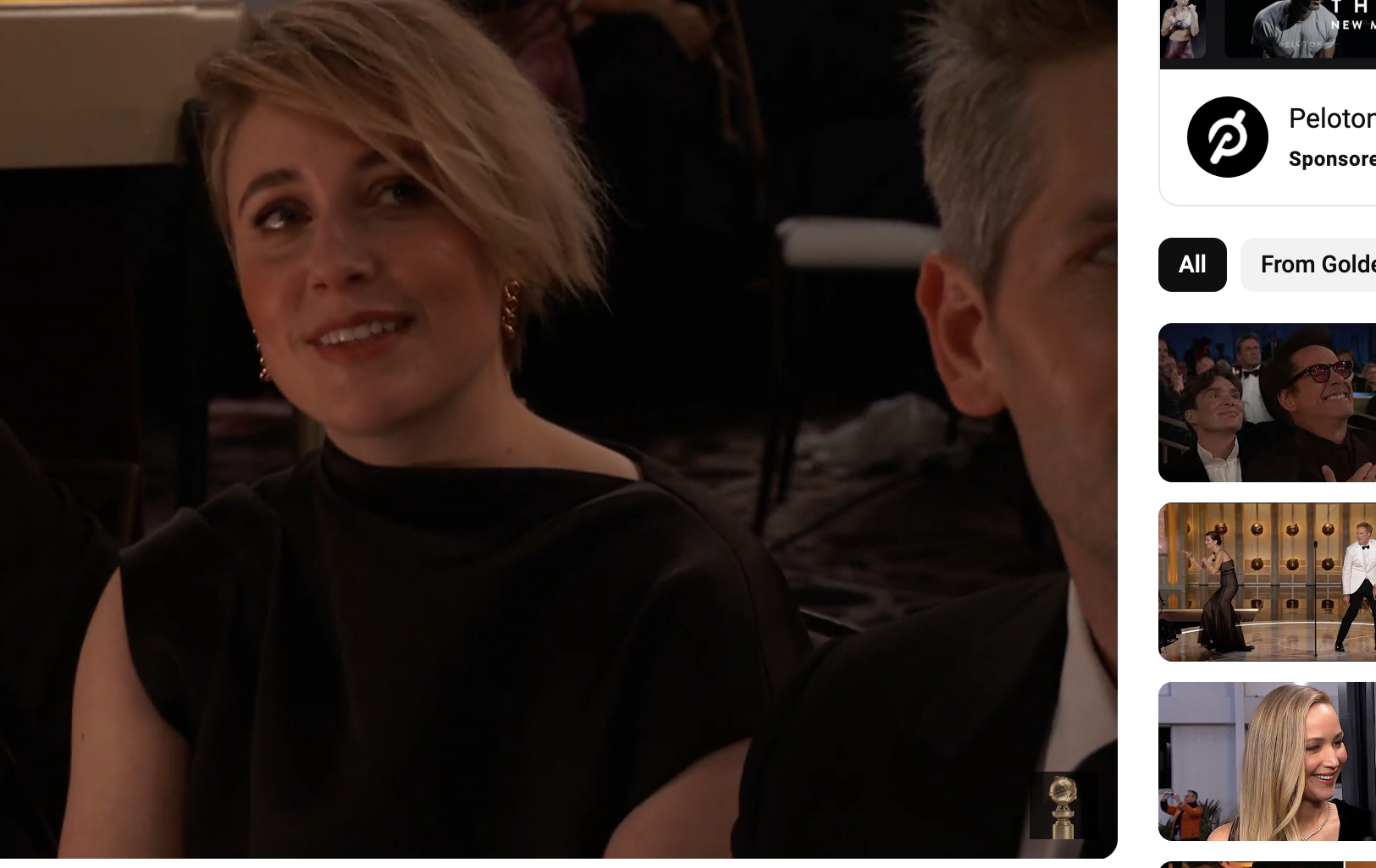 A closeup of Greta Gerwig sitting in the audience