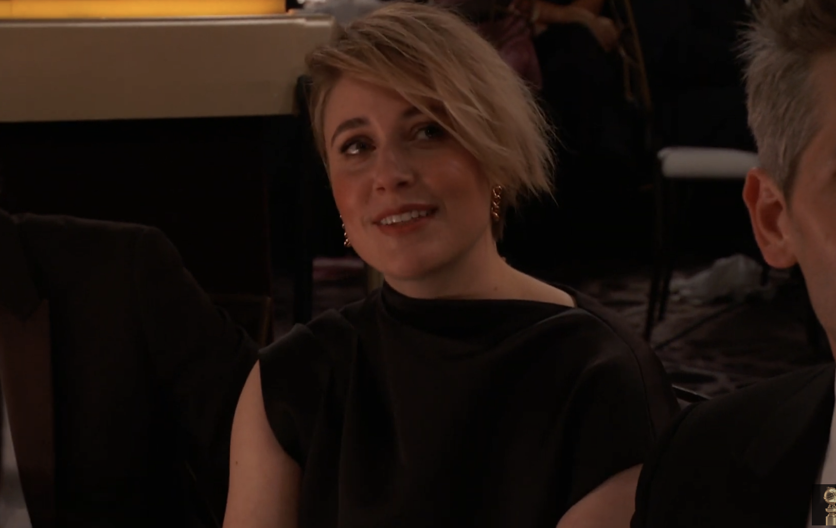 A closeup of Greta Gerwig sitting in the audience