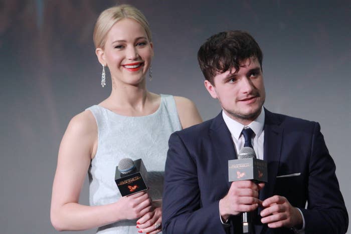 Jennifer and Josh holding microphones as they stand onstage