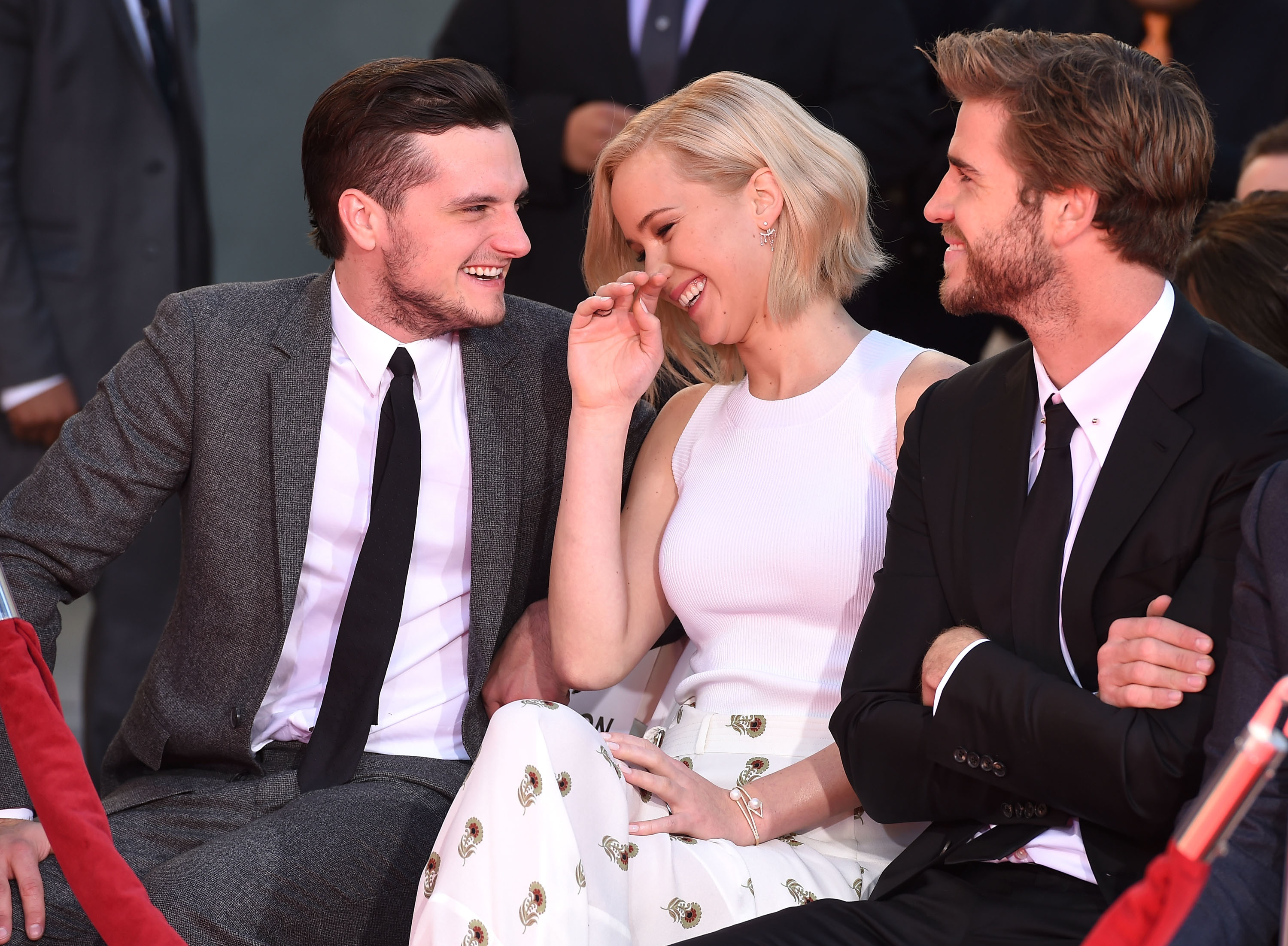 Josh and Jennifer laugh as Liam smiles and looks on
