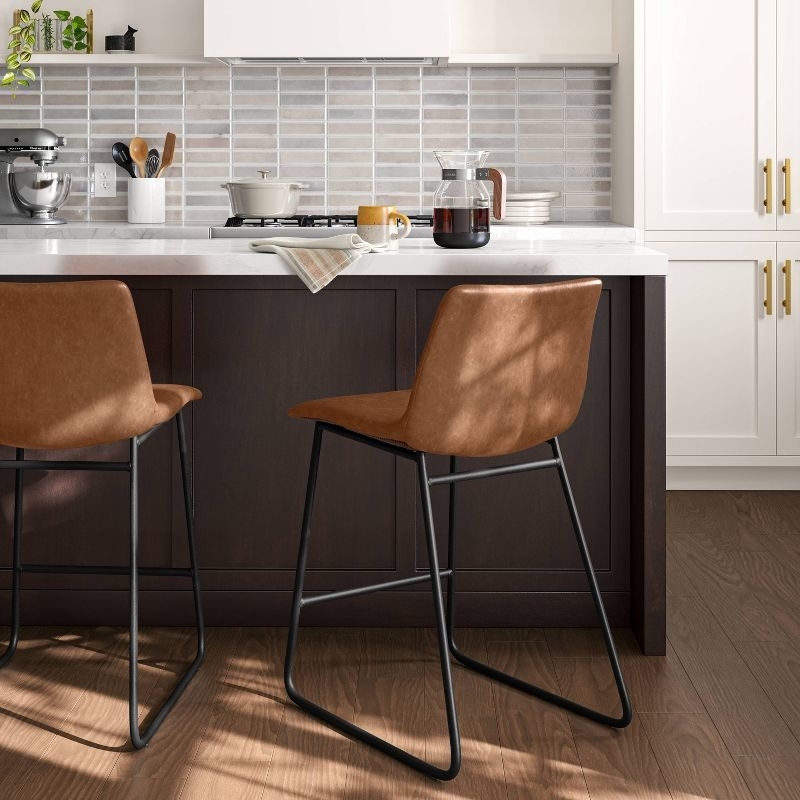 Two brown counter-height barstools in kitchen