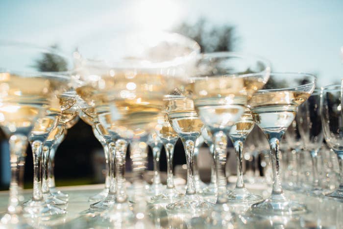 Champagne glasses lined up on a table