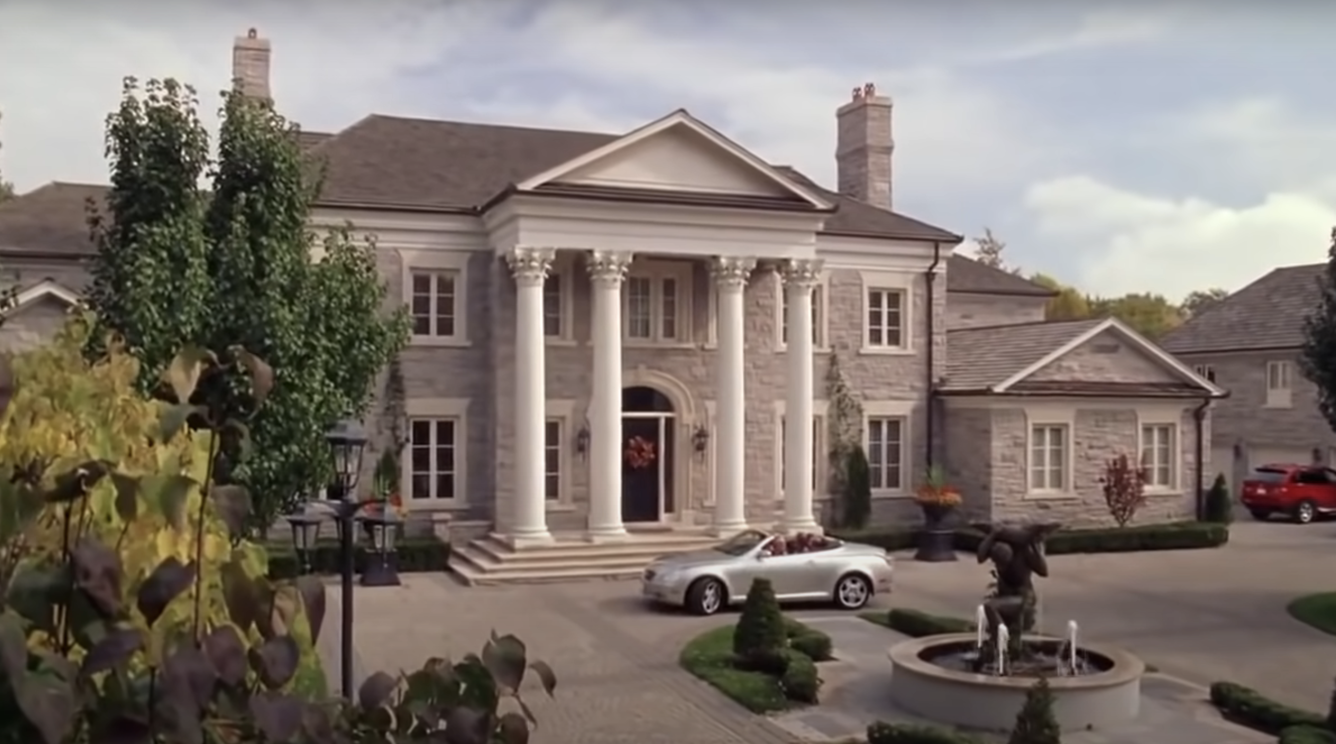 large mansion with a convertible outside
