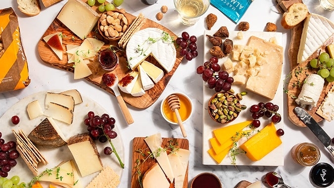 the international cheese box filled with different cheeses and pairings