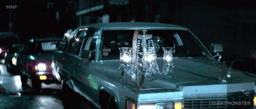 He drives a car with a disco ball on the dash and a chandelier on the hood.