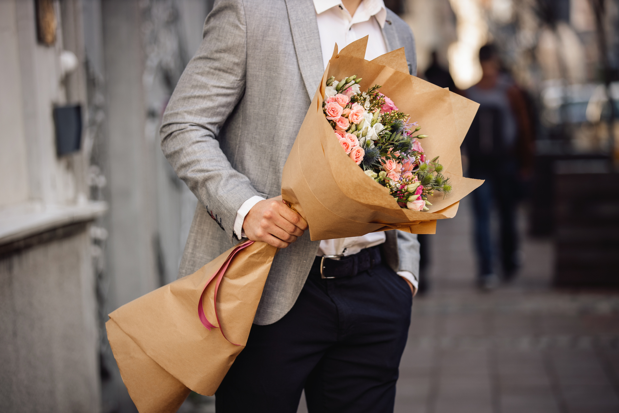 A man holding a bouquet of flowers