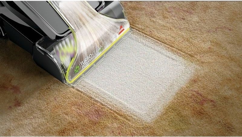 A carpet cleaner cleaning carpet