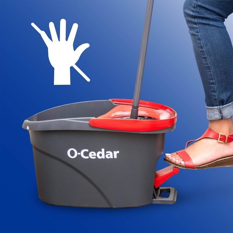 A foot pushes a spinning pedal for a mop bucket