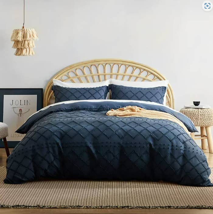 boho bedframe and dark blue bed set