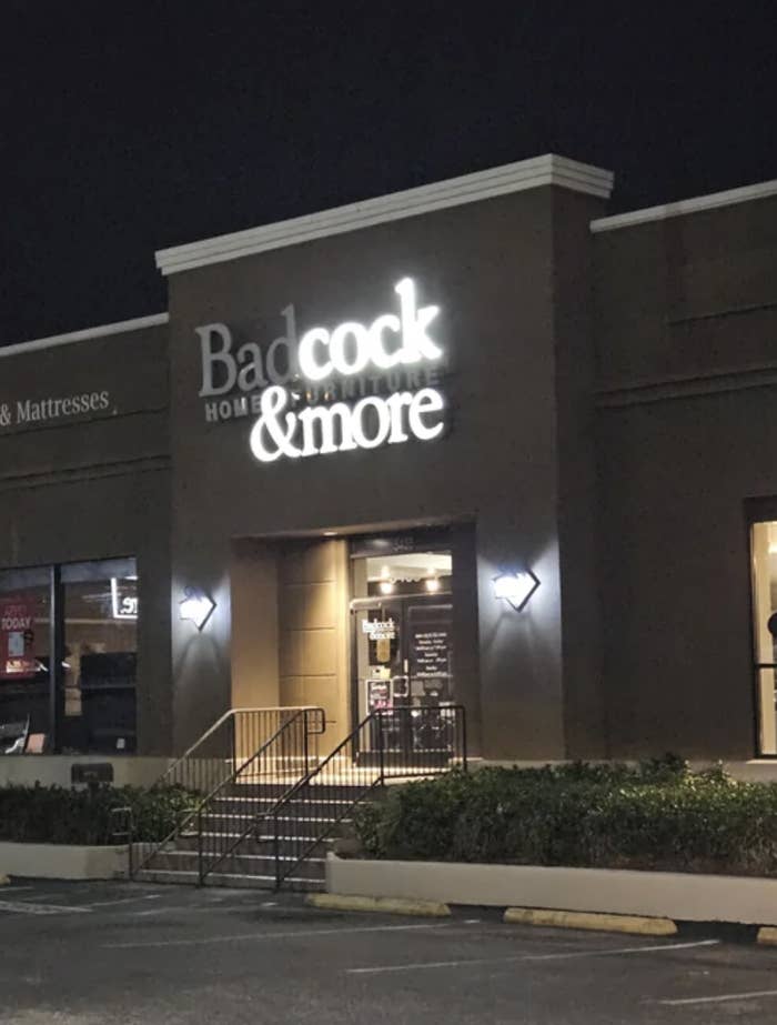 A &quot;Badcock Home Furniture &amp;amp; More&quot; sign lit up with &quot;cock&quot; and &quot;&amp;amp;more&quot; lit up