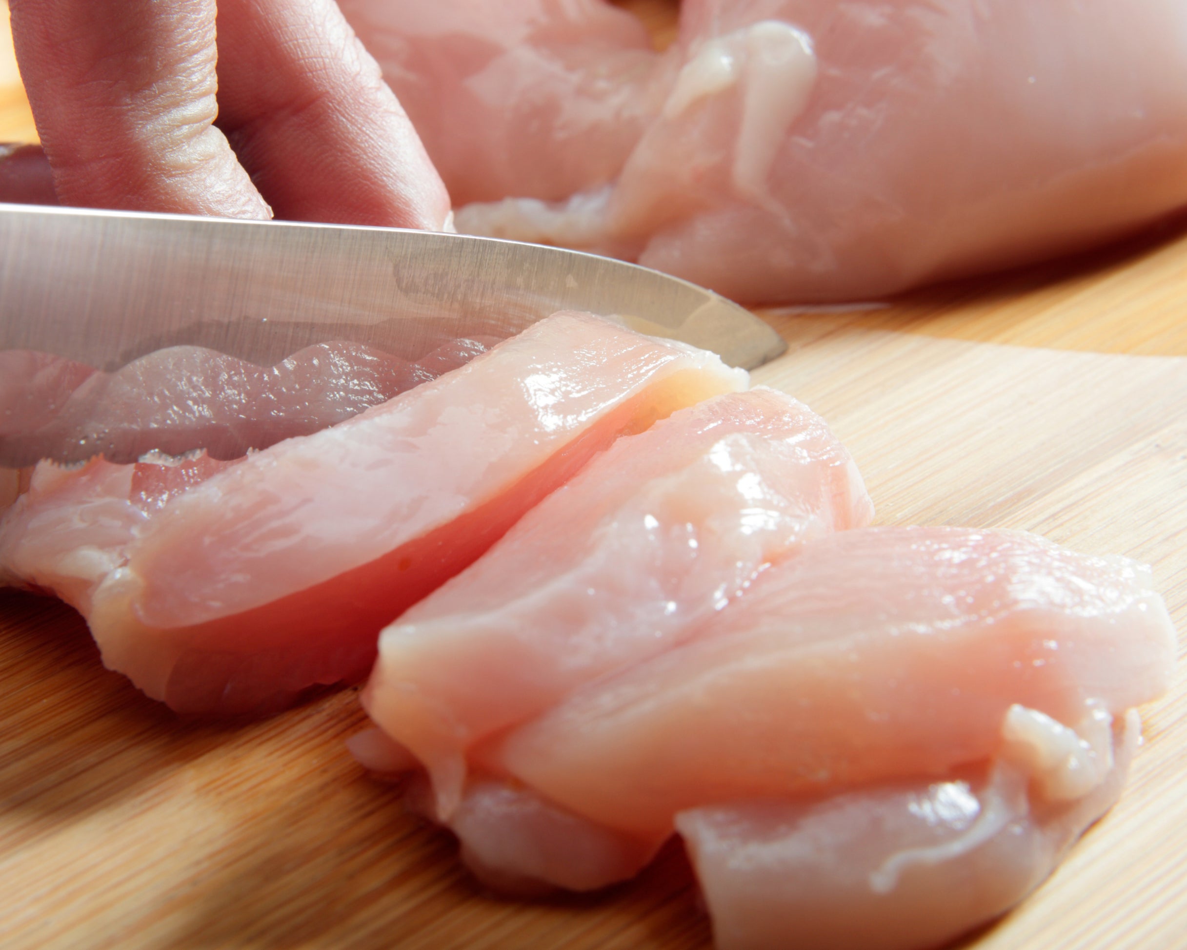 Close-up of raw chicken on a wood surface